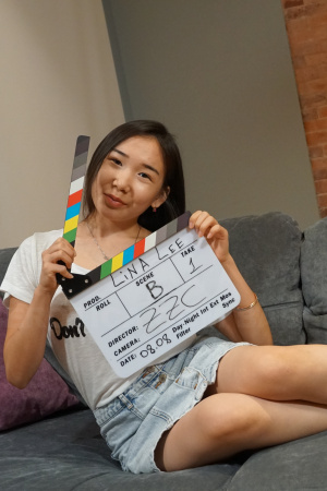 Asian Lina Lee is on a couch showing her sexy legs in short socks