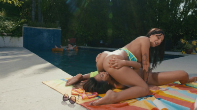 April Olsen and Jennie Rose play with each other by the pool