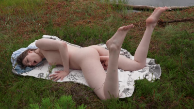 Young Margo Von Tesse masturbates solo on the lawn